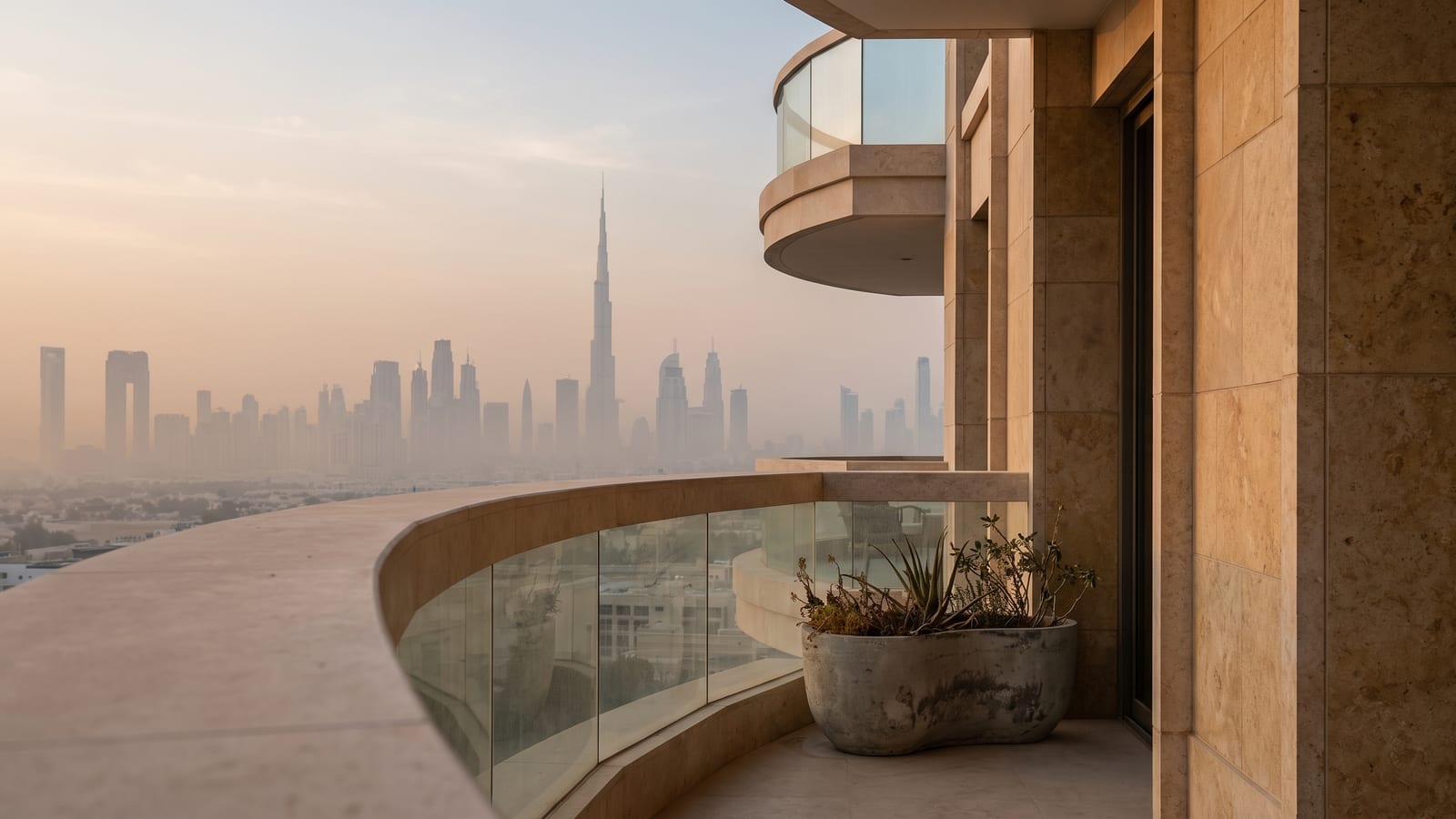 The Downtown skyline at dawn from a residential balcony, a curved balustrade in the foreground